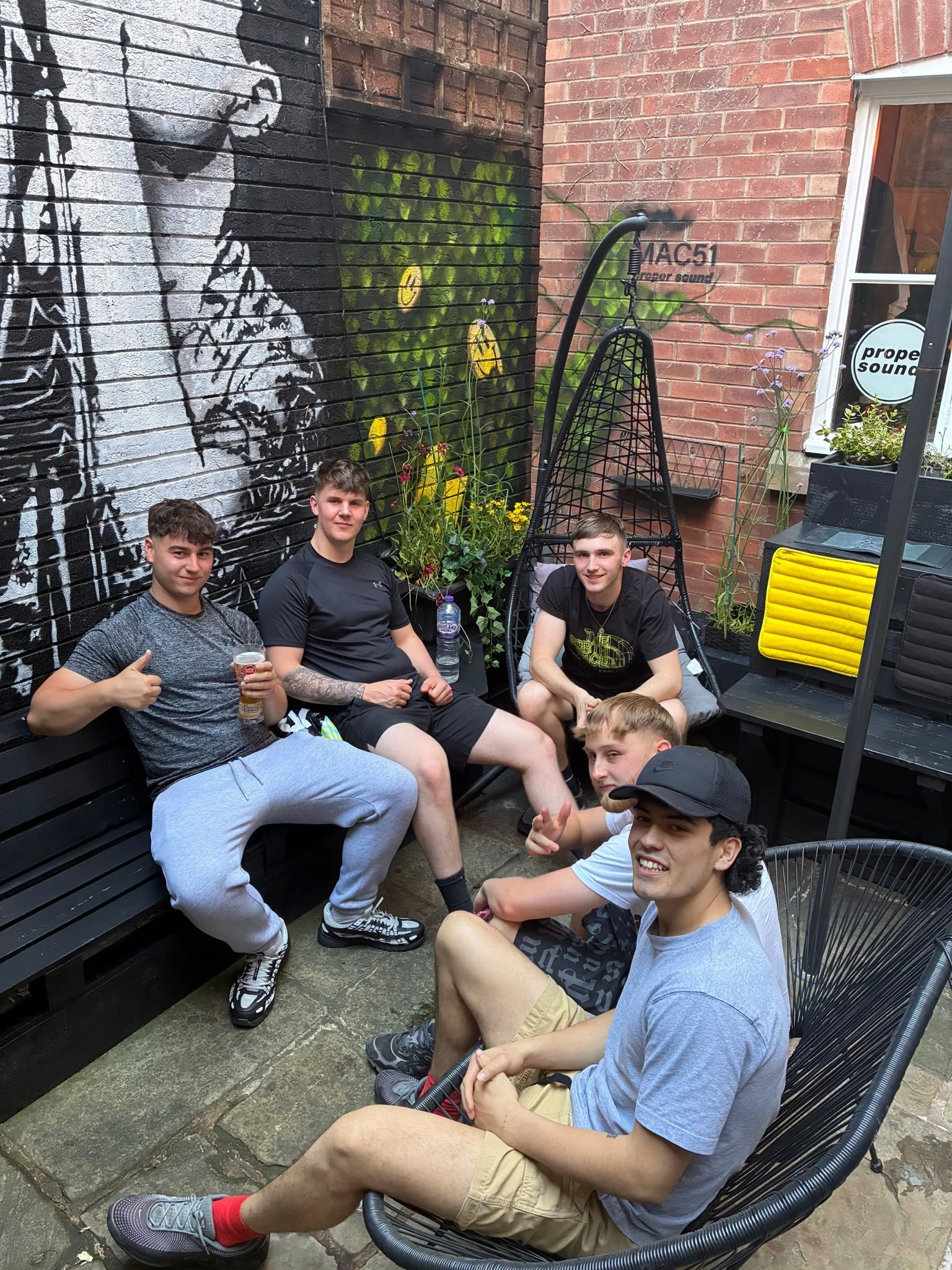 Visitors beside the Ian Curtis mural