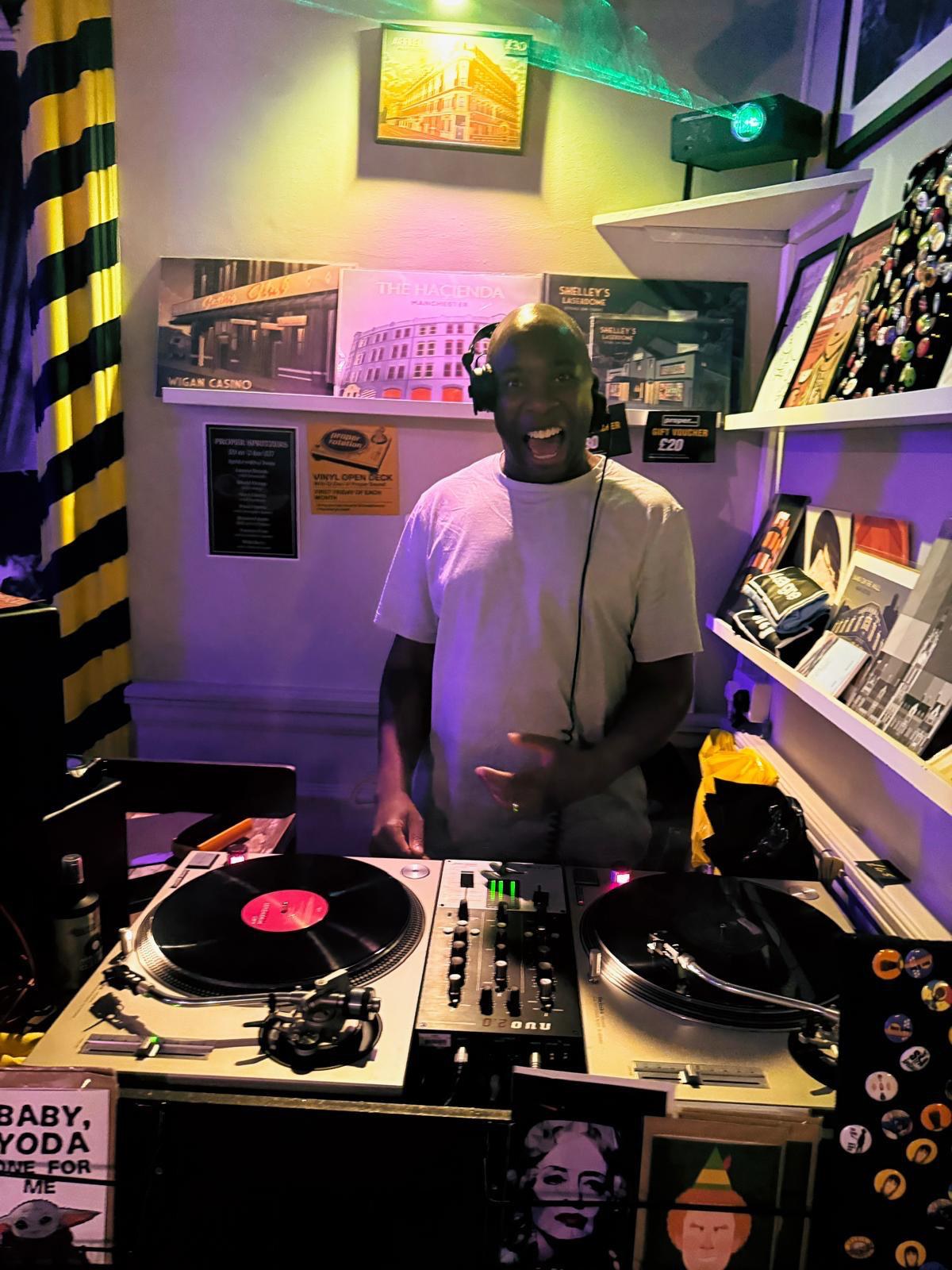 A Proper Sound DJ performing on vinyl turntables inside the venue
